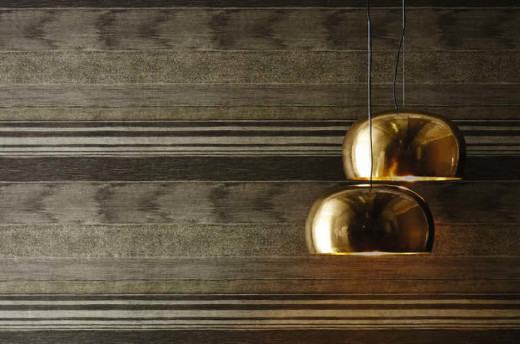 A split pendant light source: two LED light bulbs from the one ceiling connection doubles up the reflection from windows during daylight. The wide-plank 'walnut' pattern on the "Stucco" wallpaper is from Harlequin Group's 2014 spring collection.