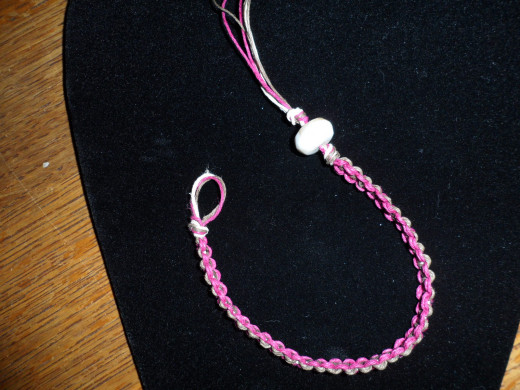 Add the bead and tie another knot.