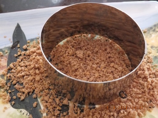 Take a nice flat dish and sprinkle in part of that 3/4 cup of whole wheat panko you set aside. Place your biscuit cutter in the center.