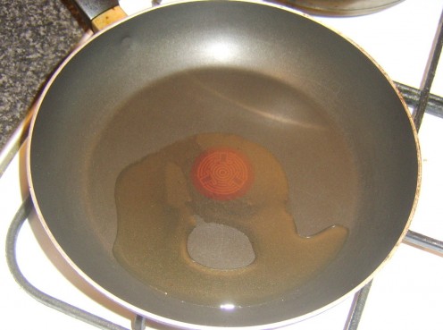 Vegetable oil is heated in non-stick frying pan