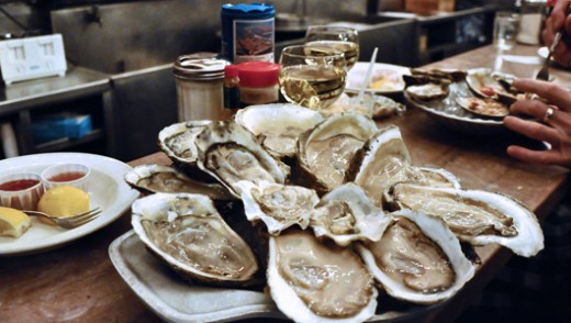 Above in the photo are raw oysters on the half shell which are so delicious. Serve hot sauce, fresh lemon slices and saltine crackers to go with the raw oysters on the half shell. 