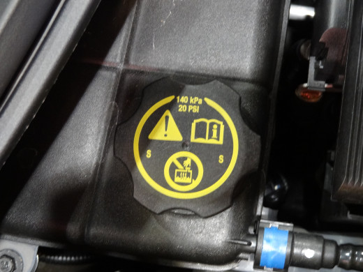 Caution: Never open a hot radiator cap. Most radiator caps are in the 13 to 15 PSI range but, some newer vehicles have 20 PSI caps.