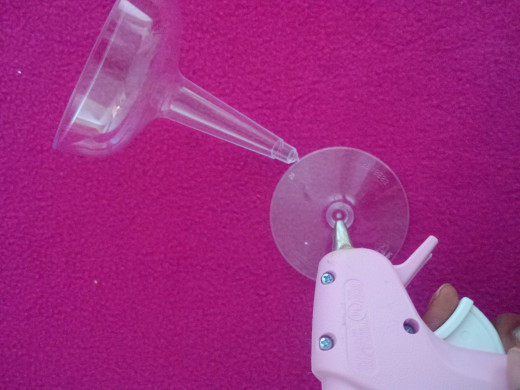 Use the glue gun to secure the bottom piece of the glass to the top piece.
