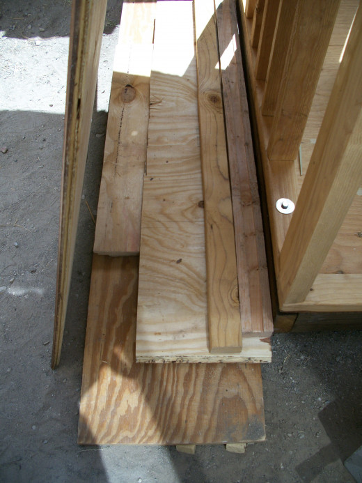 Build up a platform on which to prop up siding.  A short crowbar was used to pry the siding into position before a screw was driven home on each side.