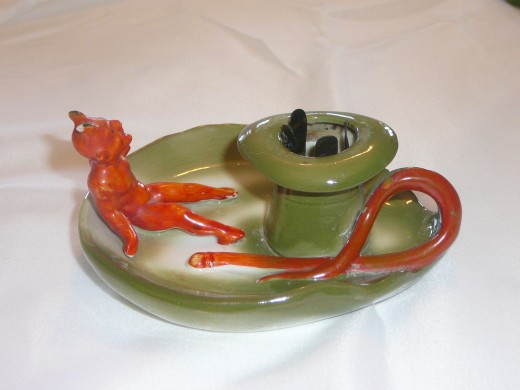 Devil candlestick. I'm sure the heat won't bother him! 4 1/2" x 2". Paid $37.