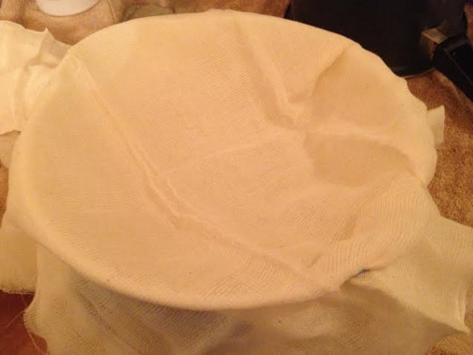 Take a piece of cheesecloth and secure it to the top of a bowl.