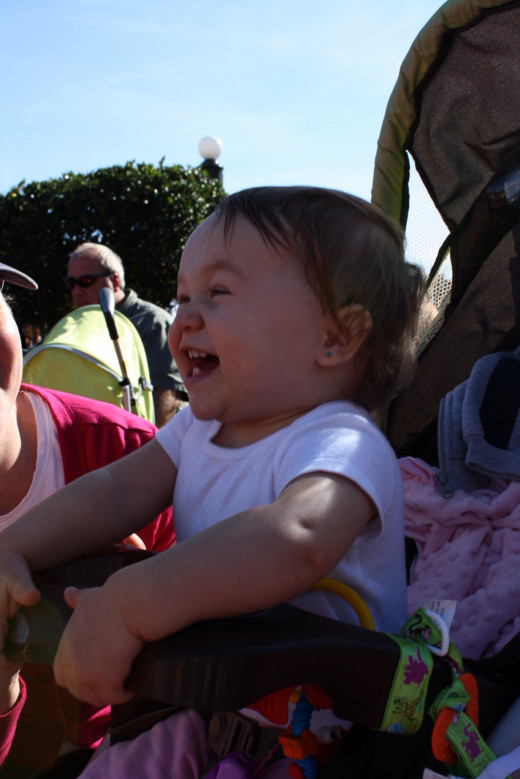 The parades and street shows are excellent for the young travelers. In this photo, Sweets (age 1) is having a blast watching a show at Cinderella's castle. 
