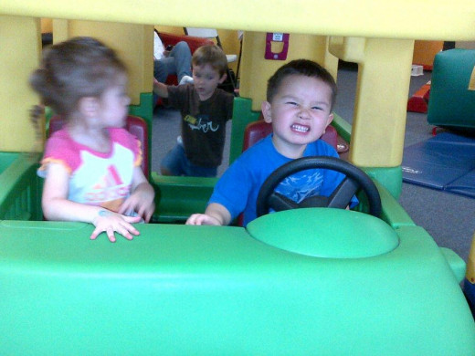 I am pretty sure the little girl is telling him to slow down and turn the car around.