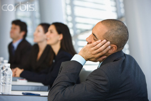 The salesman is simply bored out of skull at some boring sales conference