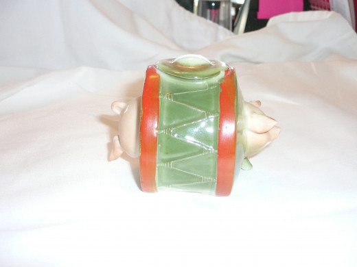 This is a drummer pig bank. Featured in "This little Piggy" its '92 price was $210. 4" x 3". Paid $61. Common.