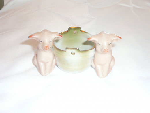 Two pigs by a bucket.  Featured in "This little Piggy" its 1992 value was $45. There is also a more rare edition with bears also valued at $80 but I wouldn't be surprised if it got more. $3 1/4" x 1 1/4". Paid $45 Common