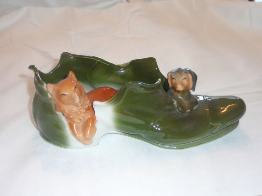 German Shepherd and Dachschund in a shoe.The only one I've seen on ebay of its kind. 7" x 2 1/4". $45. Rare.