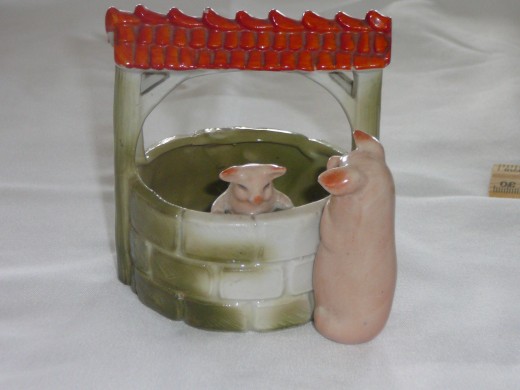 This adorable Momma and baby pig are at the wishing well. You can still see the bricks although some of the patina has worn off. Featured in "This little Piggy" the '92 price was $140. 4" x 3 3/4". Paid $91. Rare