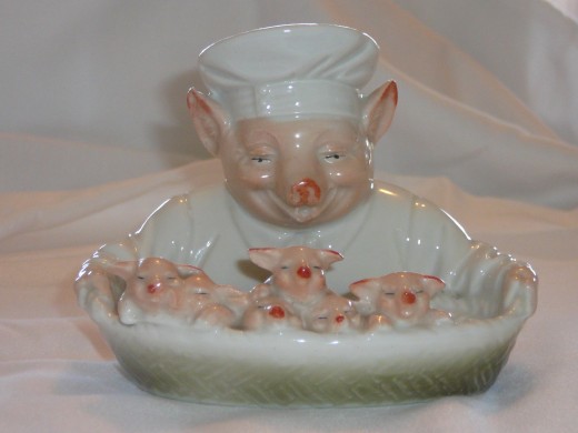 This amazing chef is holding a basket with 6 little pigs" Featured in "This little Piggy" its '92 value was $475. I've only seen it come up on ebay twice. 5" x 4" Paid $313. Rare.