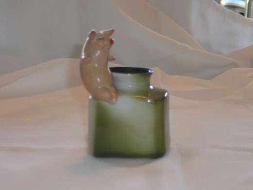 Piggy on an inkwell getting ready to write a letter I suppose. Featured in "This little Piggy" its '92 price was $60. 2" X 3 1/2". Paid $40. Rare.
