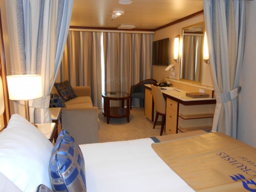 This photo shows the stateroom TV in the living room area of the min-suite with a second TV not shown but on the wall on the left, at the foot of the bed.