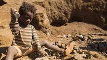 A young girl breaking-up rocks