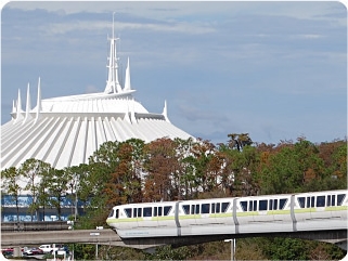 A monorail passes by with Space Mountain in the background.