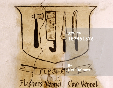 The crest of a Scottish artisans guild. The crests of nobility often displayed symbolic images; but guild crests displayed the tools craftsman members worked with. Compare this to the crossed hammer or wrenches of a modern trade union. 