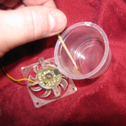I used a toothpick to transfer small amounts of the oil to the bearing shaft of the fan. I used a toothpick to transfer small amounts of the oil to the bearing shaft of the fan.