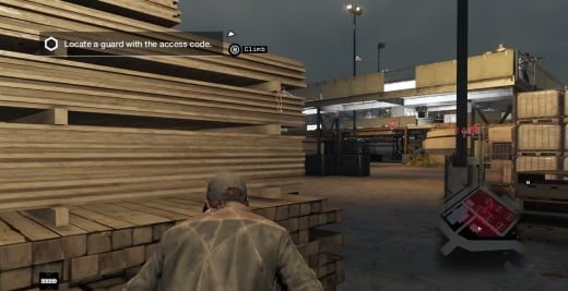 Aiden hides behind a stack of lumber while infiltrating the Brandon Docks ctOS Centre in Watch_Dogs.