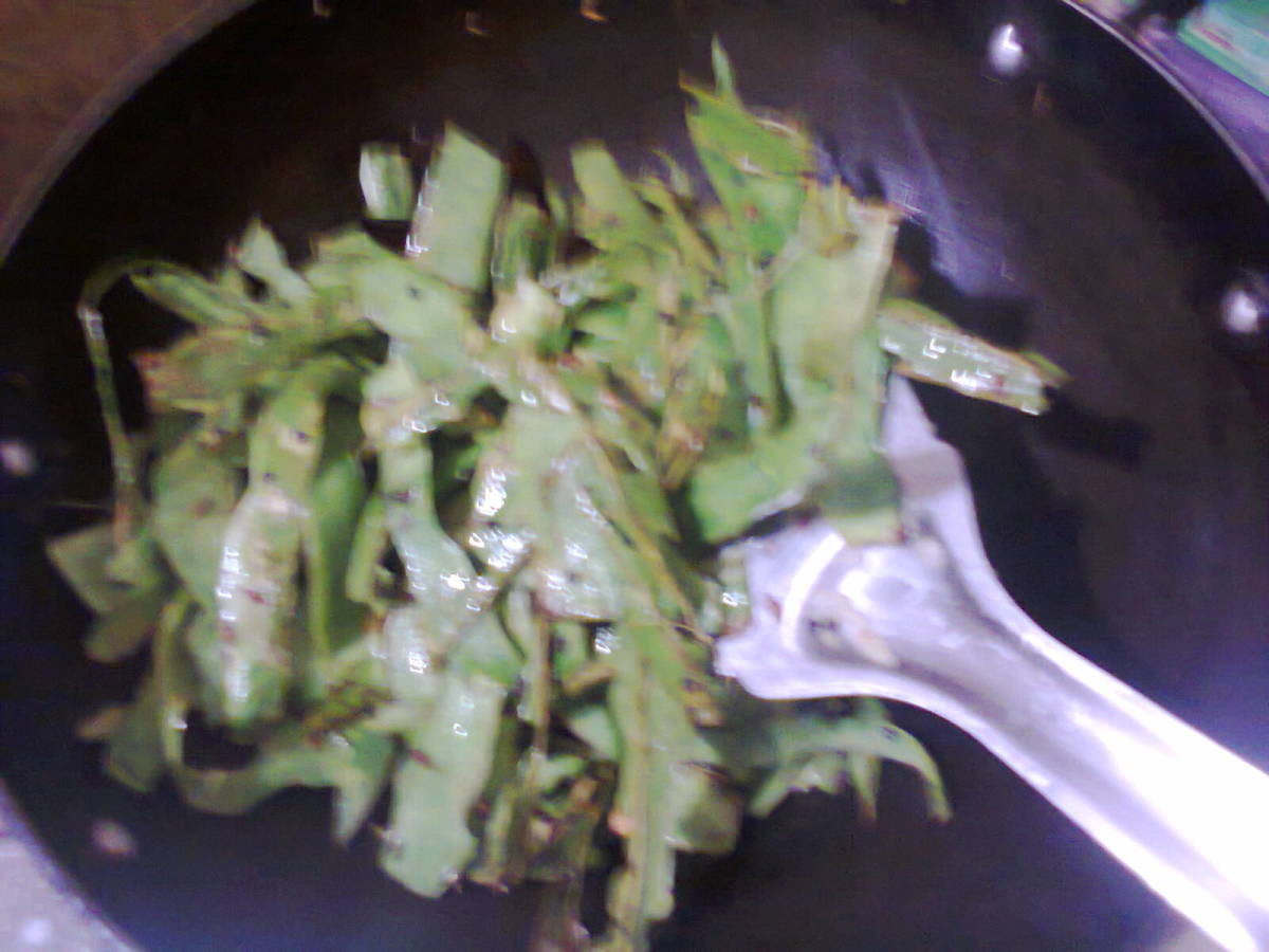 Ingredients being turned and fried in fry pan