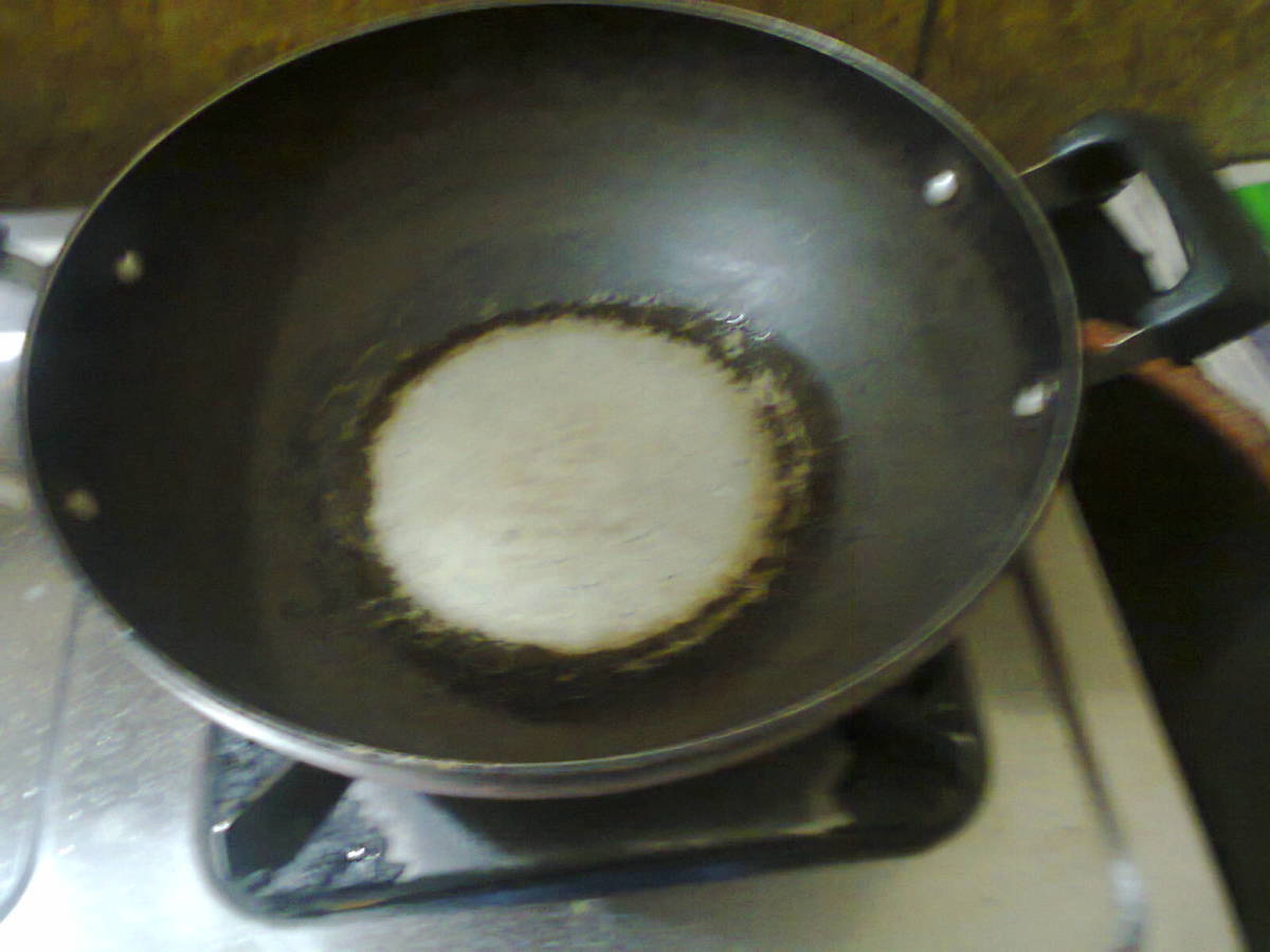 Frying pan with a spoonful of oil