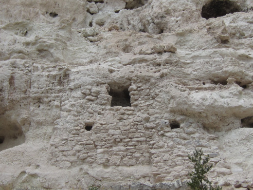 Ruins of a room in Castle A.  Circular holes are post holes where Sycamore beams were inserted into cliff for support.