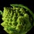 This is a Romanesco Broccoli, often used to illustrate the principal and appearance of Fractal Geometry in nature. You can cut it up for slaw, too.