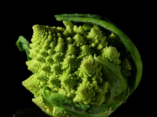 This is a Romanesco Broccoli, often used to illustrate the principal and appearance of Fractal Geometry in nature. You can cut it up for slaw, too.
