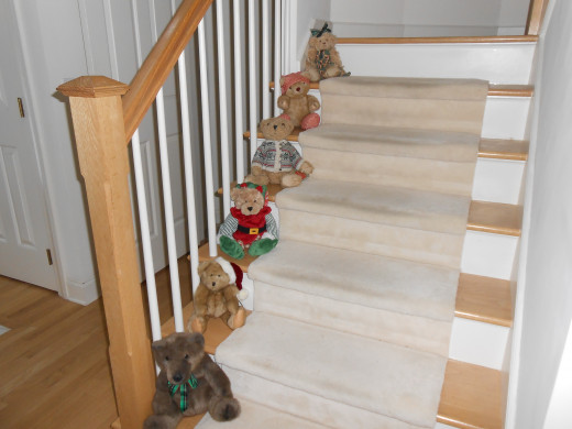 Teddy bears on the front stairs offer a warn holiday greeting to Christmas visitors, but I know I need to clean and polish the wood on the stairs first!