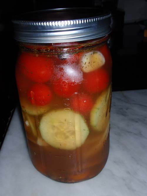 Pickled cucumbers topped with grape tomatoes