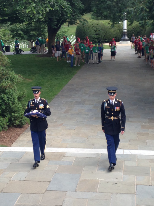 AFTER HAVING LOWERED THE FLAG AT 5:00 PM, THE GUARDS RETURN IT TO REST FOR DUTY THE NEXT DAY