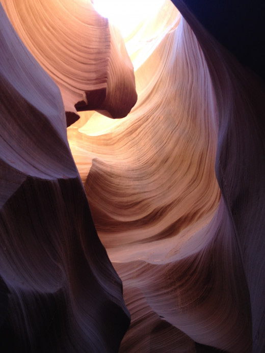 Swirling water rushing trough Lower Antelope Canyon has resulted in spiraling, corkscrew shaped canyon walls