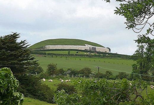 Newgrange off in the distance with sheep grazing in the foreground. Photo by Jon Sullivan. 