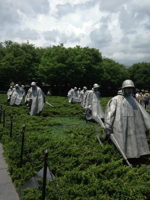 SQUAD OF KOREAN VETS MOVING THROUGH THE FIELD