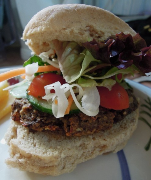 A vegan mushroom burger with salad.