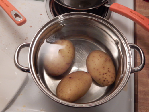 Put the potatoes in when the water's cold, and lid them so they boil faster.  Photo by JenPaxton