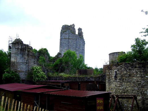 The ruined towers of Lastours castle looms above the trees