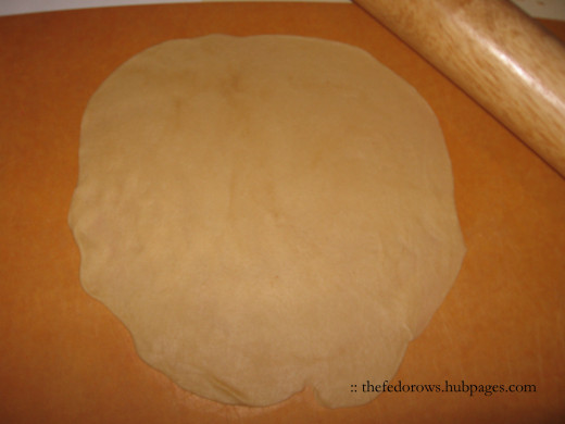 Flatten the dough with the heels of your hands first, then with a rolling pin. 