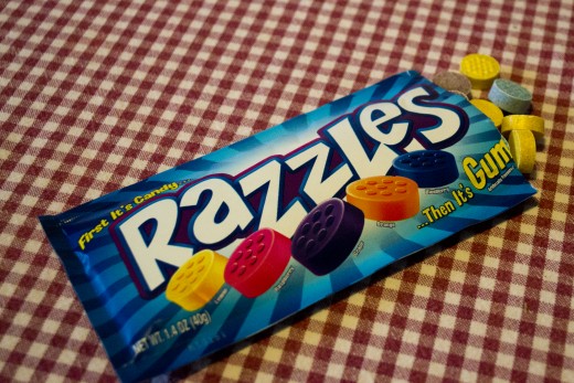 Razzles come in a blue packet with various flavor candies inside.
