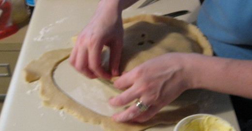 The top dough and the bottom dough need to pinched into a seal around the whole pie.