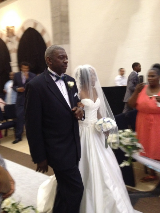 Father and Bride Walk Down The Isle.