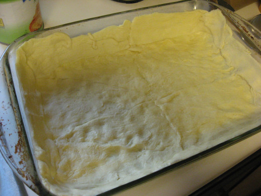 Line the baking dish with the crescent roll crust.