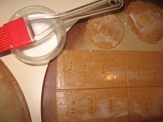 8. Spread a little extra milk over the tops of the crackers with a brush.  Sprinkle cinnamon sugar on the top, if desired (1/4 tsp cinnamon with 3/4 tsp sugar).  Bake at 375 degrees for 15-25 minutes.  