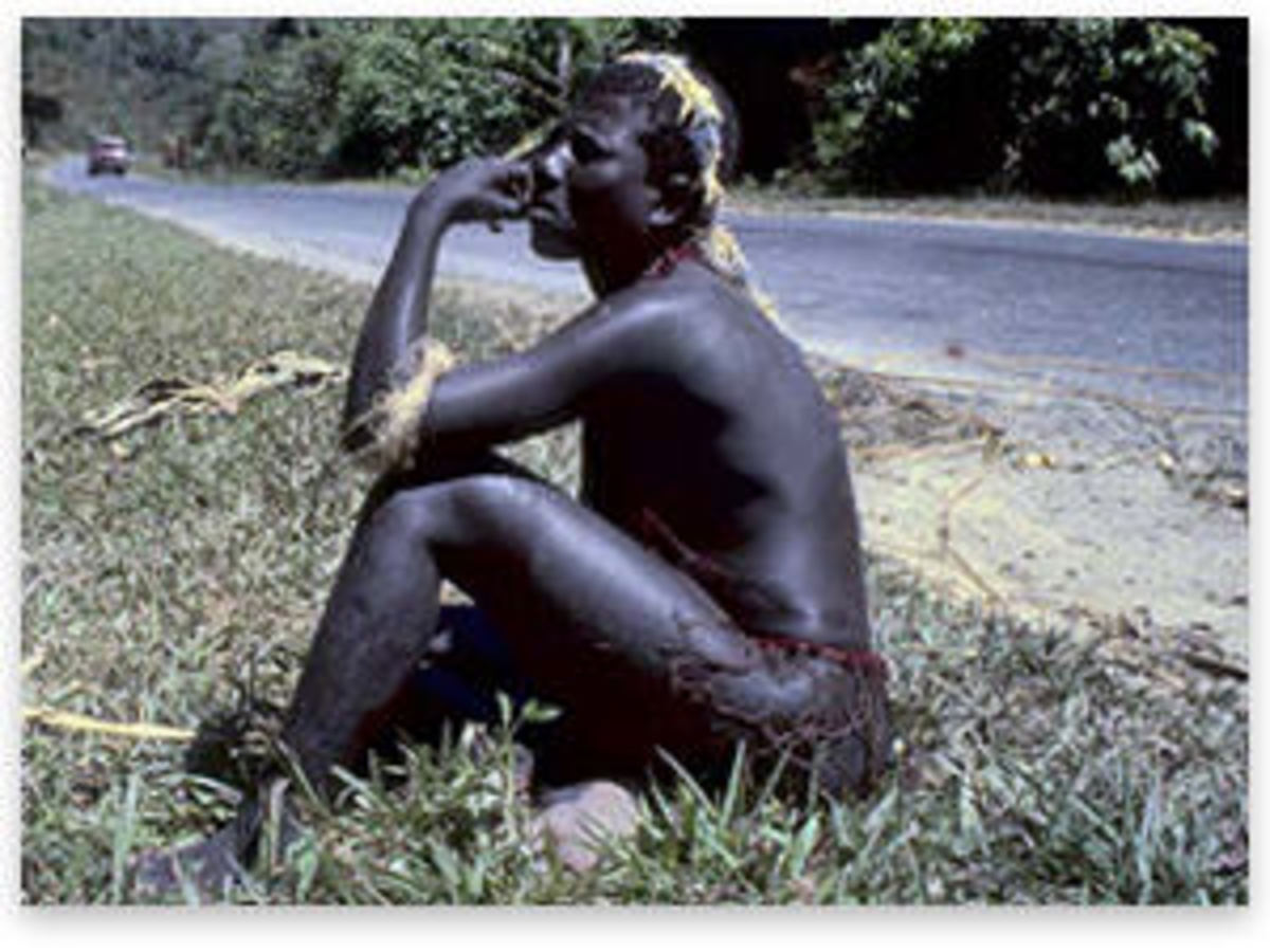 A Jarawa man sitting on the roadside