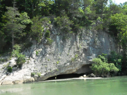 A cave lies along the river beneath this bluff