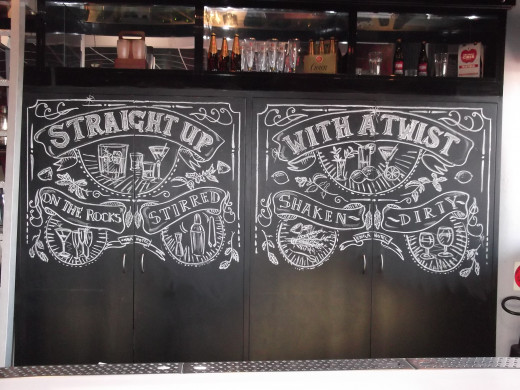 Designed on the spot. Done in oil pastel. The lower half is left blank as it is not visible from the bar.