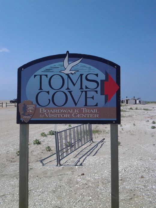 The colorful sign for the island's only public beach at Tom's Cove.