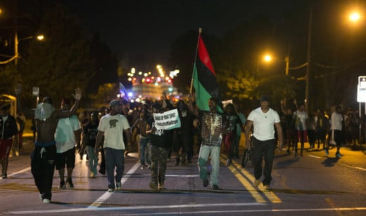 Demonstrators in Ferguson, Missouri march in unison, protesting the killing of 18 year-old Michael Brown.